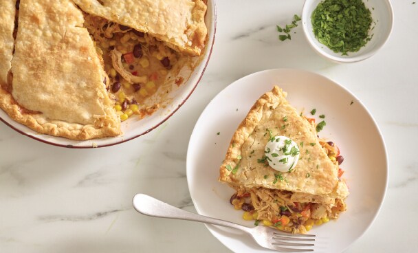 Chicken pot pie slice on a plate with a fork