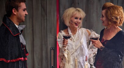 people in halloween costumes standing with cocktails