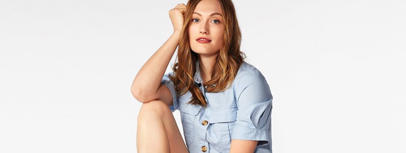 woman in blue button down shirt woman in blue button down shirt