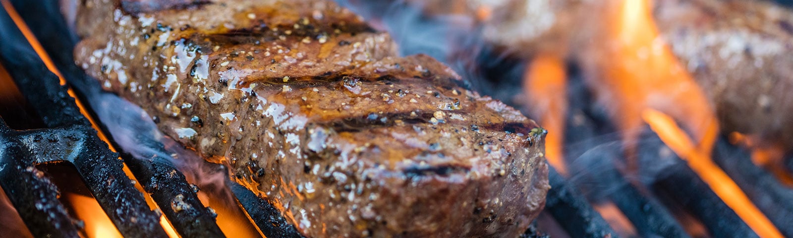 Cooked steak grilling on a grill Cooked steak grilling on a grill