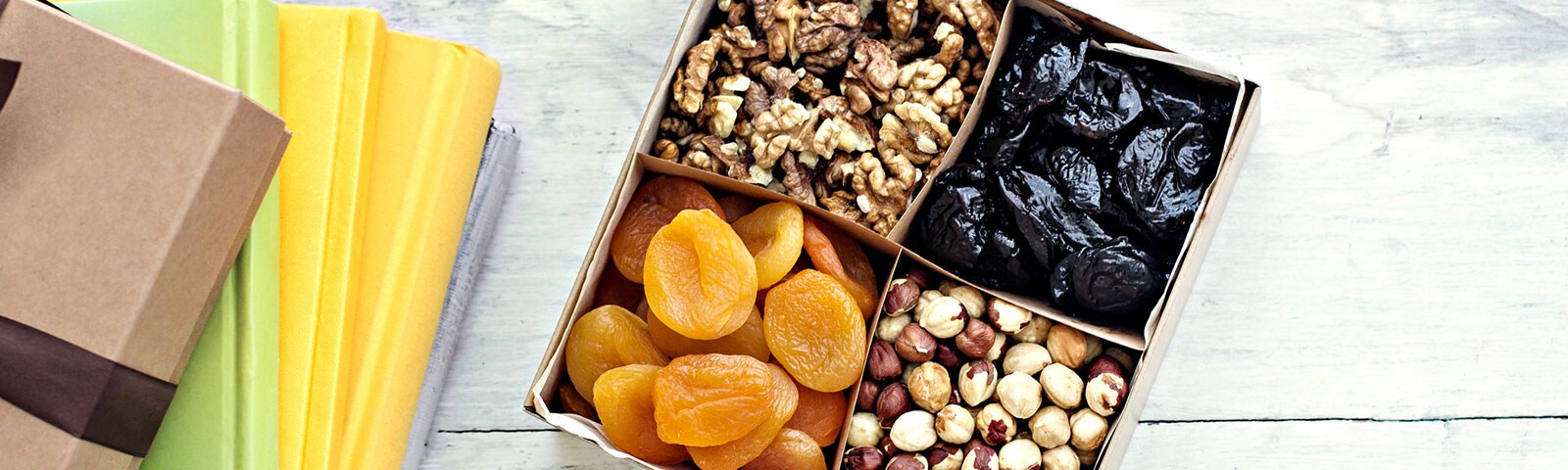 sectioned snack box containing dried fruits and nuts