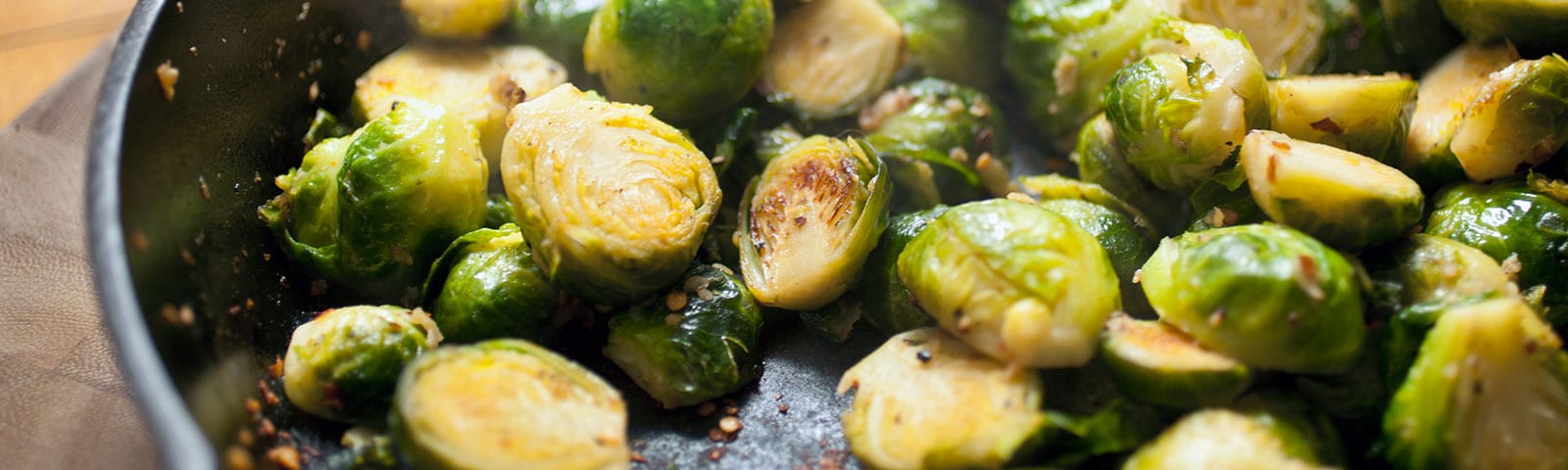 Brussel sprouts cooking in a cast iron pan