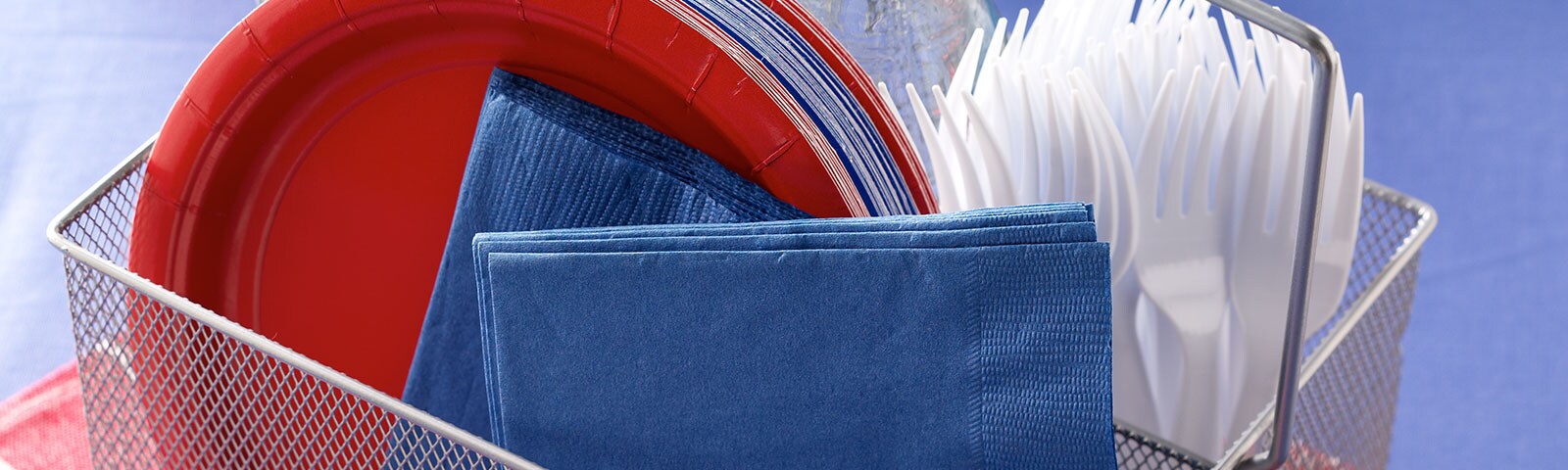 Paper plates and napkins in a wire basket