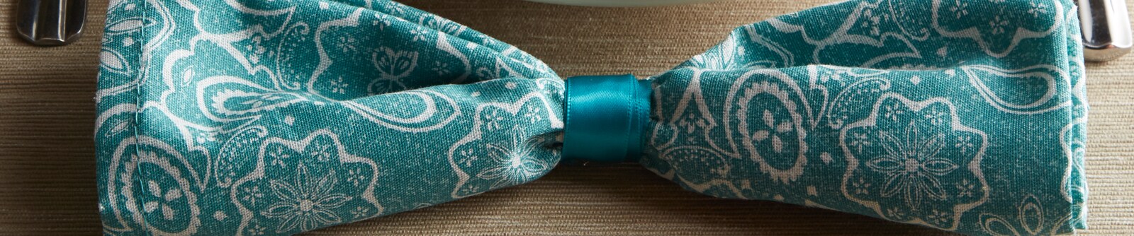 Close up of a blue paisley bow-tie Close up of a blue paisley bow-tie