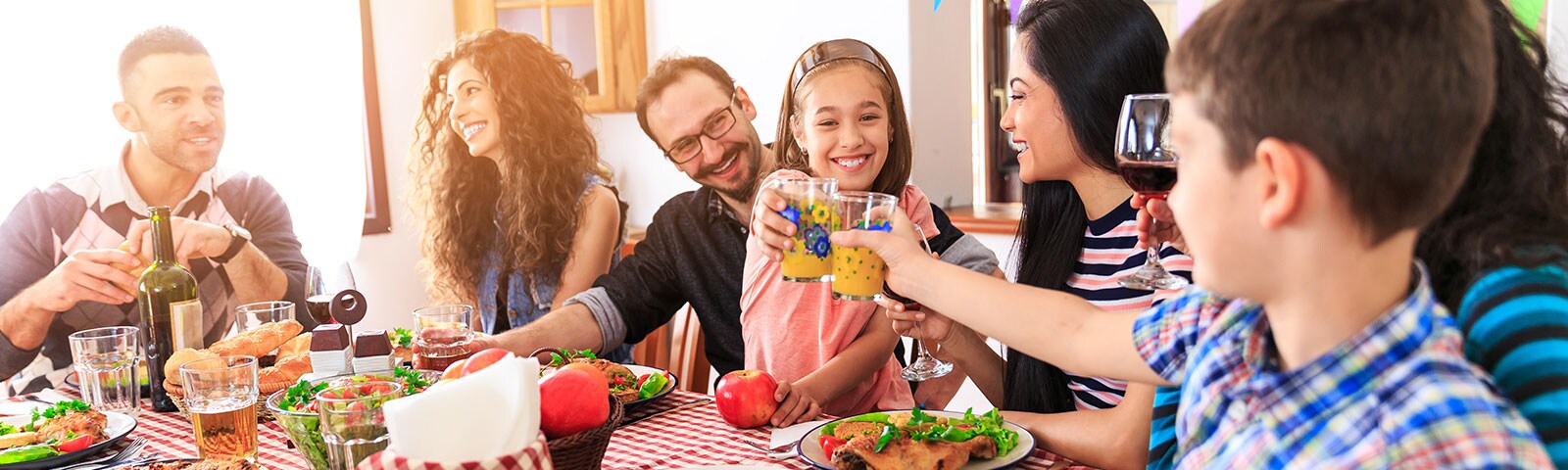 Family and friends gathering around table with drinks Family and friends gathering around table with drinks